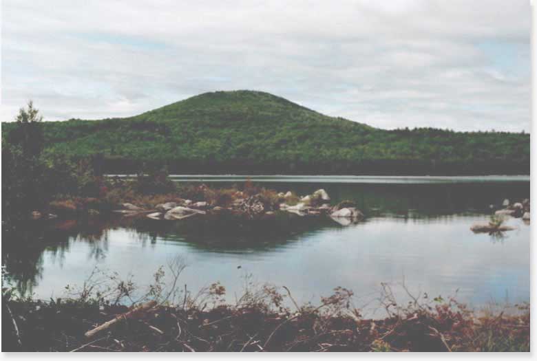 MM 21.2. Here is Little Boardman Mountain, as viewed from across Crawford Pond. It is the first little mountain you climb in a good while when traversing the AT southbound. Crawford Pond sits just north off of  Kokadjo-B Pond Road (MM 22.1 - road access point). Courtesy askus3@optonline.net